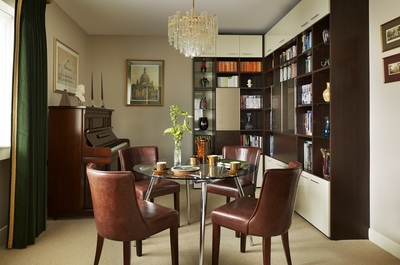 Glamorous dining room interior featuring bespoke joinery and luxurious lighting