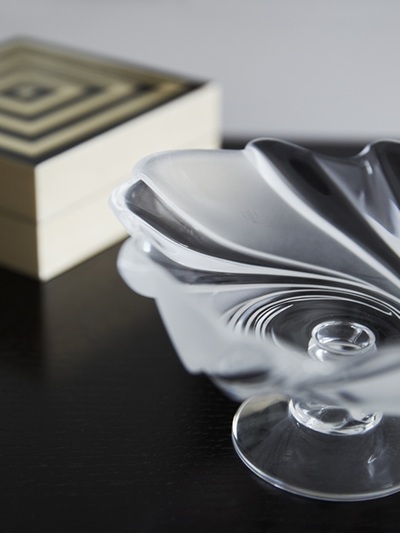 Bedroom styling details featuring an inlaid box and Lalique bowl